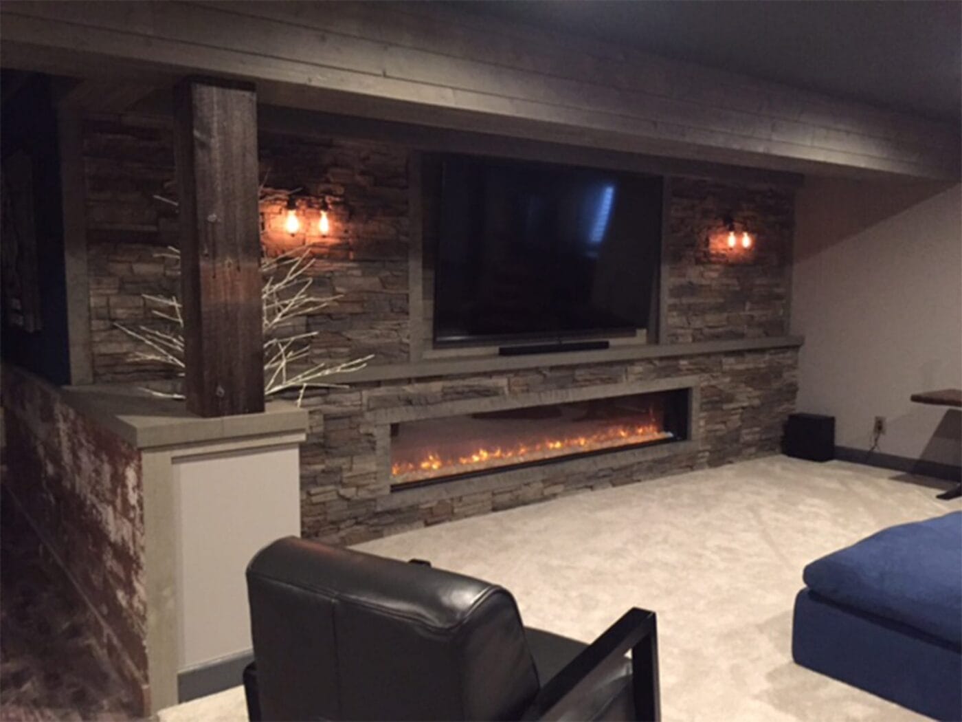 A living room accent wall and fireplace using our Kenai Stacked Stone panels.