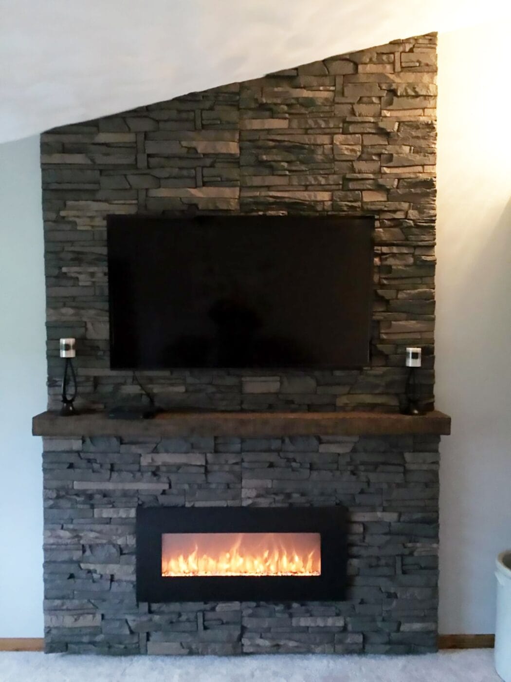 A DIY project using Stratford Stacked Stone on a built in entertainment center and fireplace.