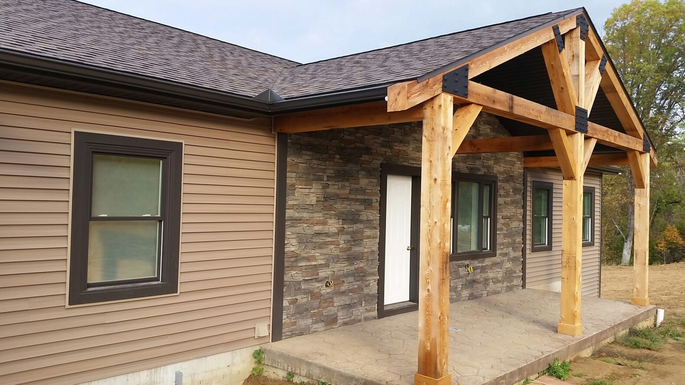 Exterior Home Design with Rock Siding and Wood Beams
