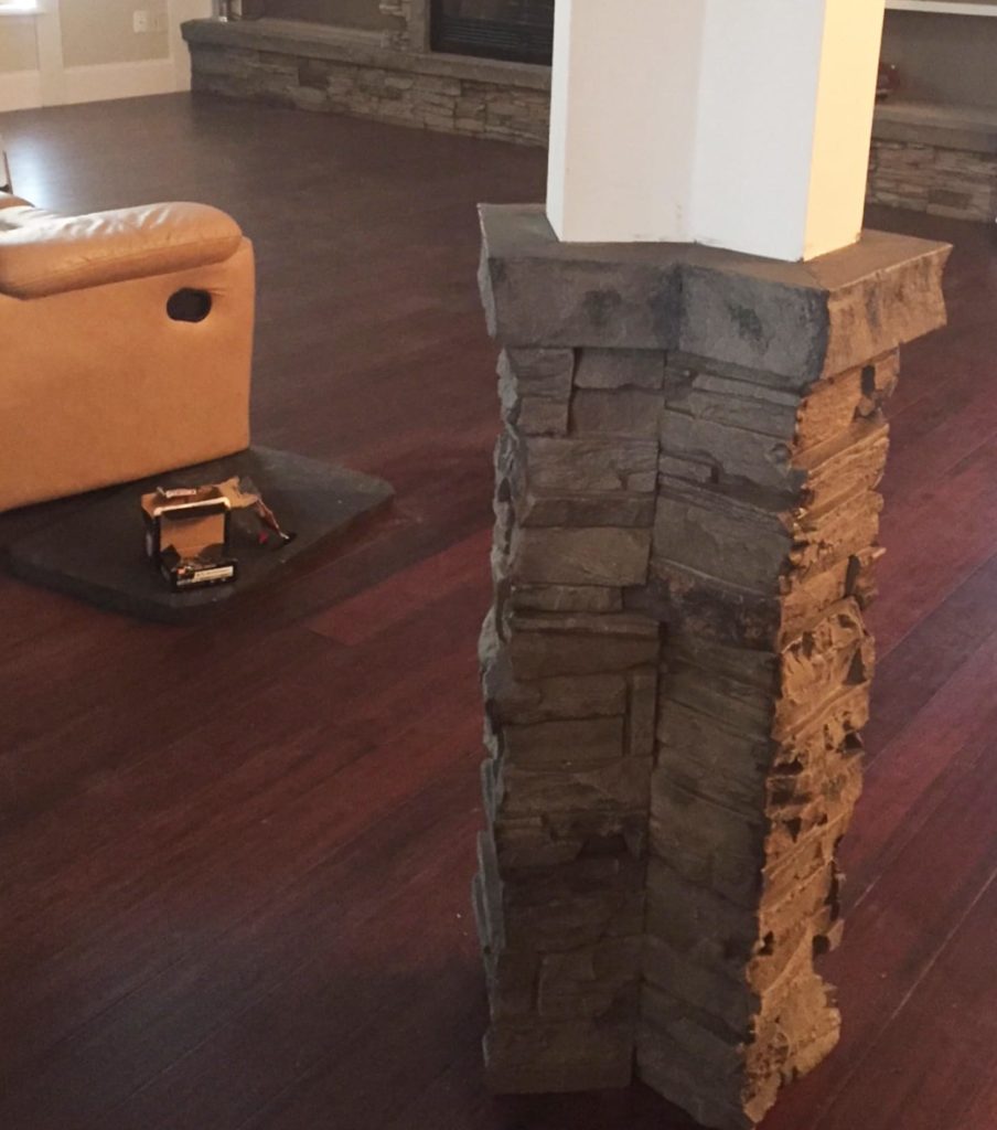A faux stone column in a home, designed with our Kenai Stacked Stone Column panels.