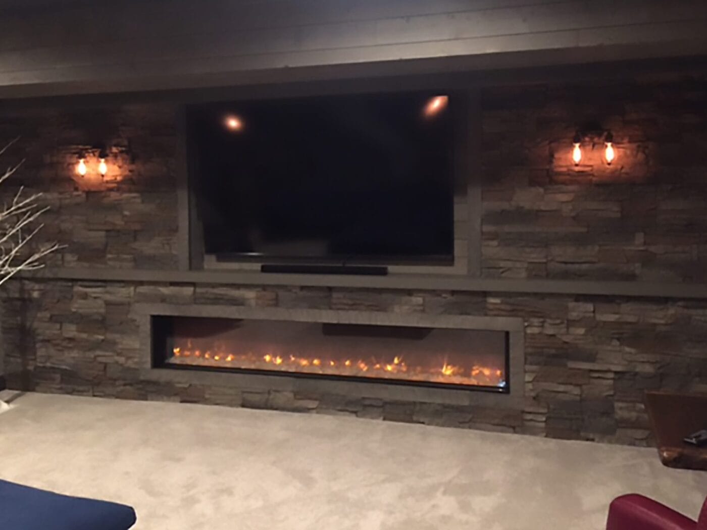 A living room accent wall and fireplace using our Kenai Stacked Stone panels.