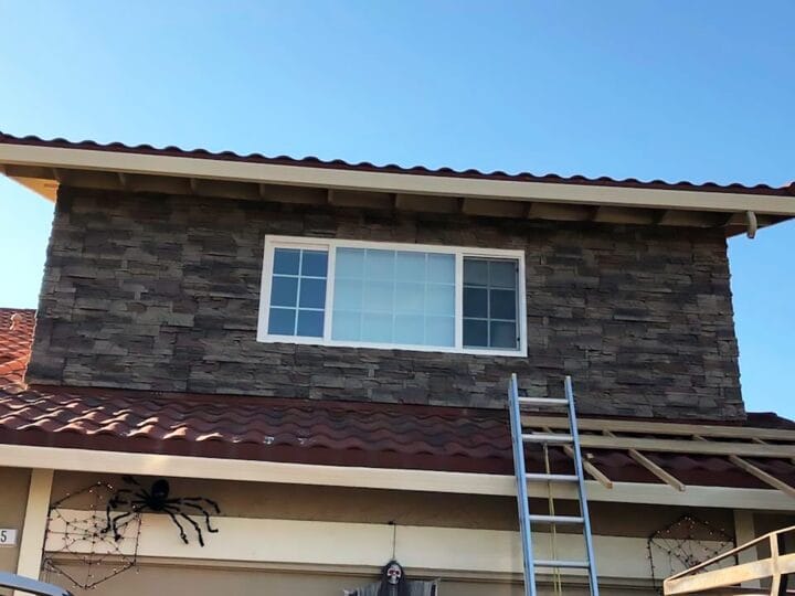 A complete cover up of an old shiplap panel project using our Kenai faux stone panels.