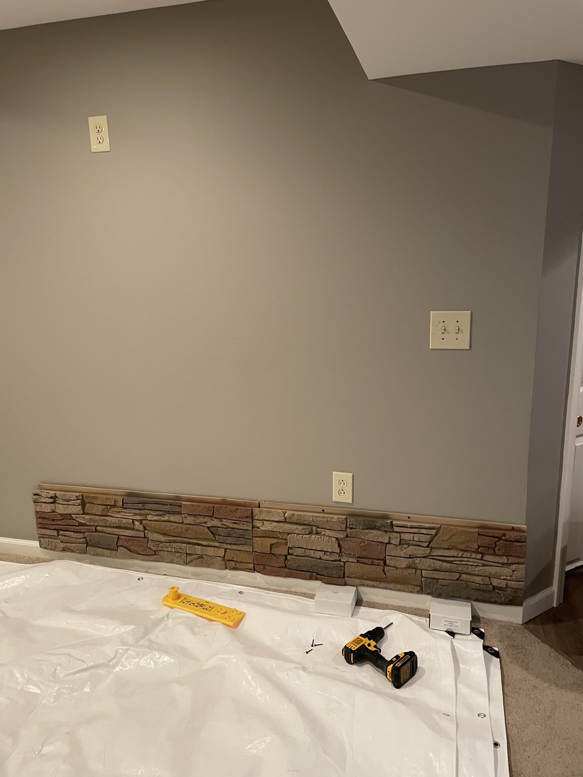 Before faux stone basement accent wall