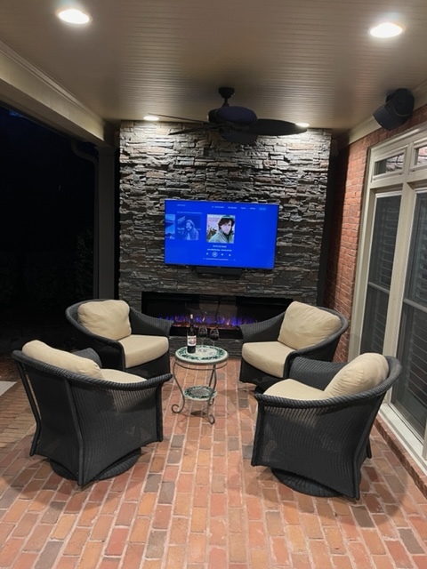 Coffee stacked stone patio fireplace tv accent wall