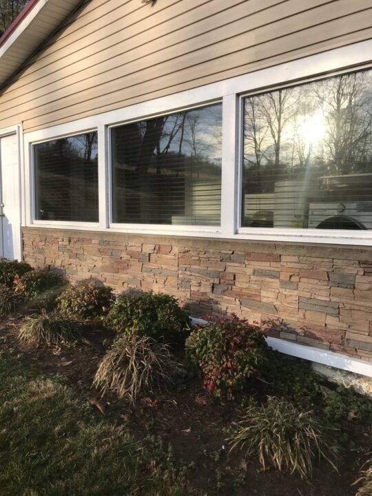 A skirting project under a window using Desert Sunrise faux stone panels.