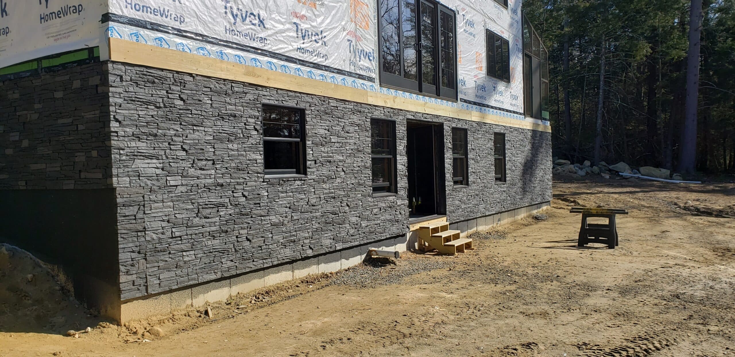 A ground floor siding project using our Iron Ore Stacked Stone panels.
