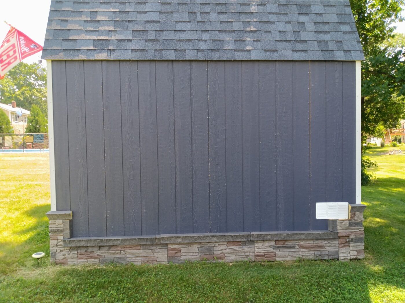 A she shed skirting project using Kenai faux stone panels.