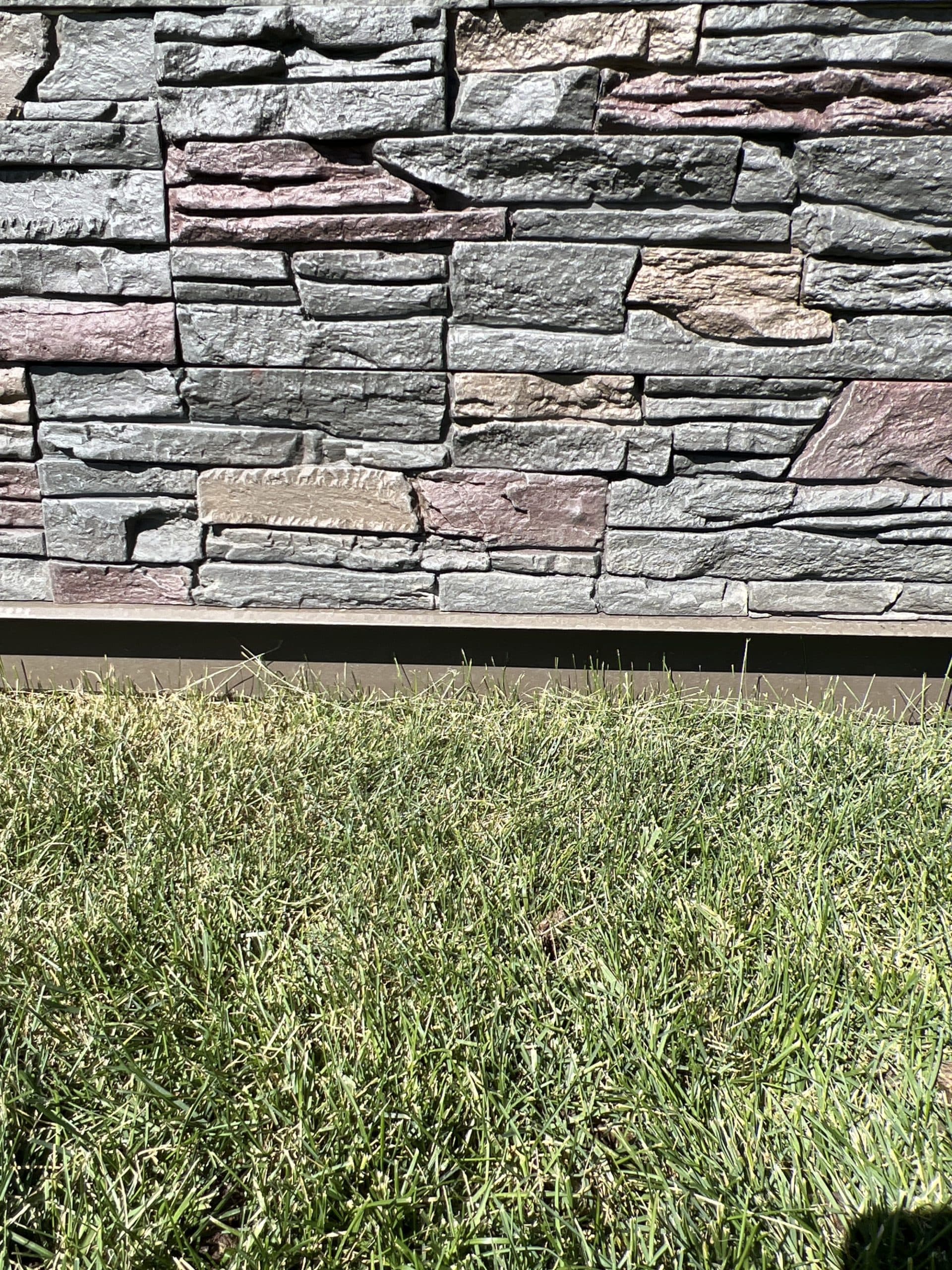 A DIY deck skirting project using Keystone faux stone panels.