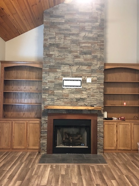 Kenai Stacked Stone Bookcase and Fireplace Design