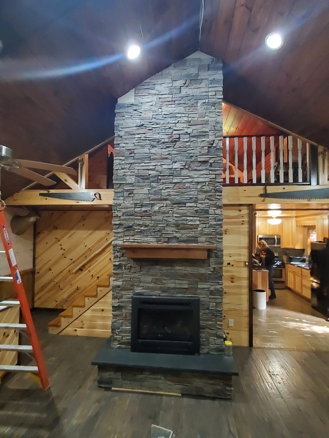 Kenai Stacked Stone Two-Story Fireplace Design Ideas