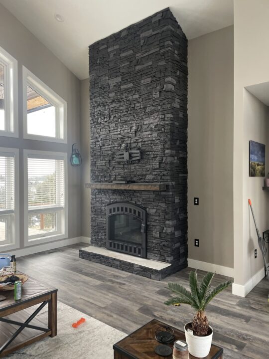 Iron Ore Stacked Stone Dark Fireplace Design