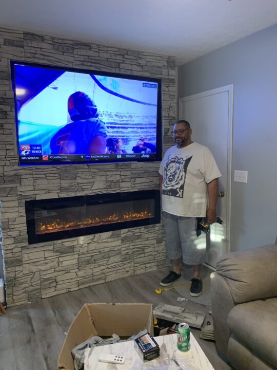 After installing Arctic Smoke Stacked Stone on a linear fireplace wall design.