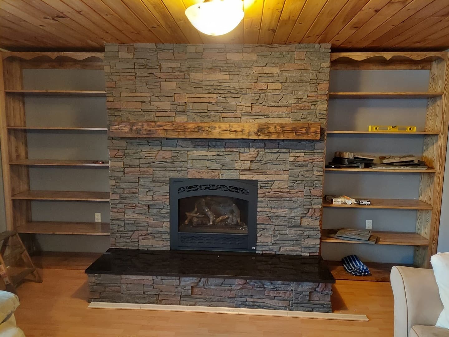 A new fireplace and bookcase with Stratford faux stone.
