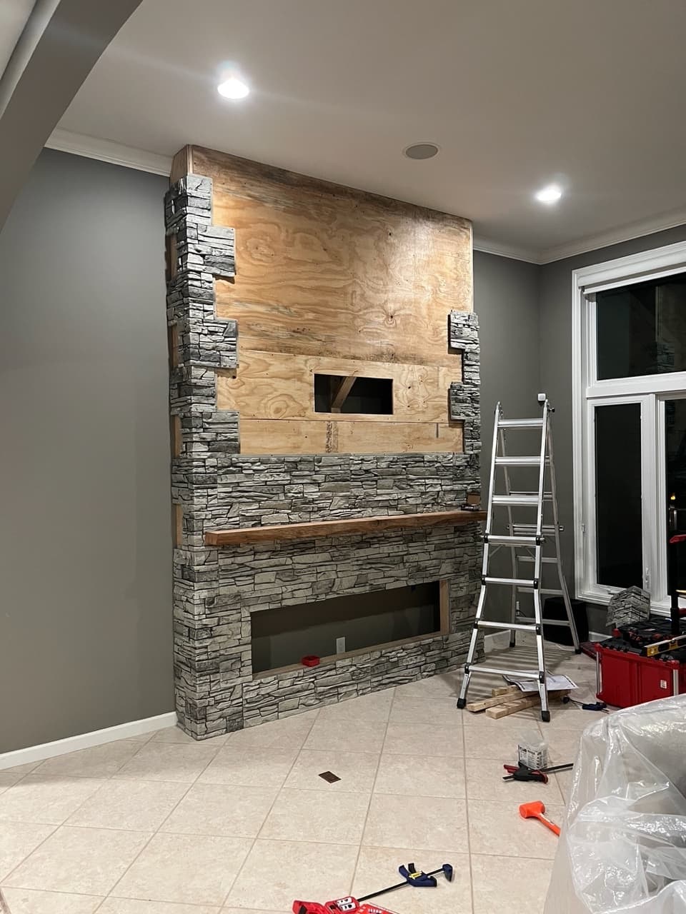 Northern Slate Stacked Stone Electric Fireplace & TV Wall Project During Installation
