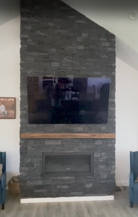 A floor to ceiling fireplace surround using Iron Ore Stacked Stone
