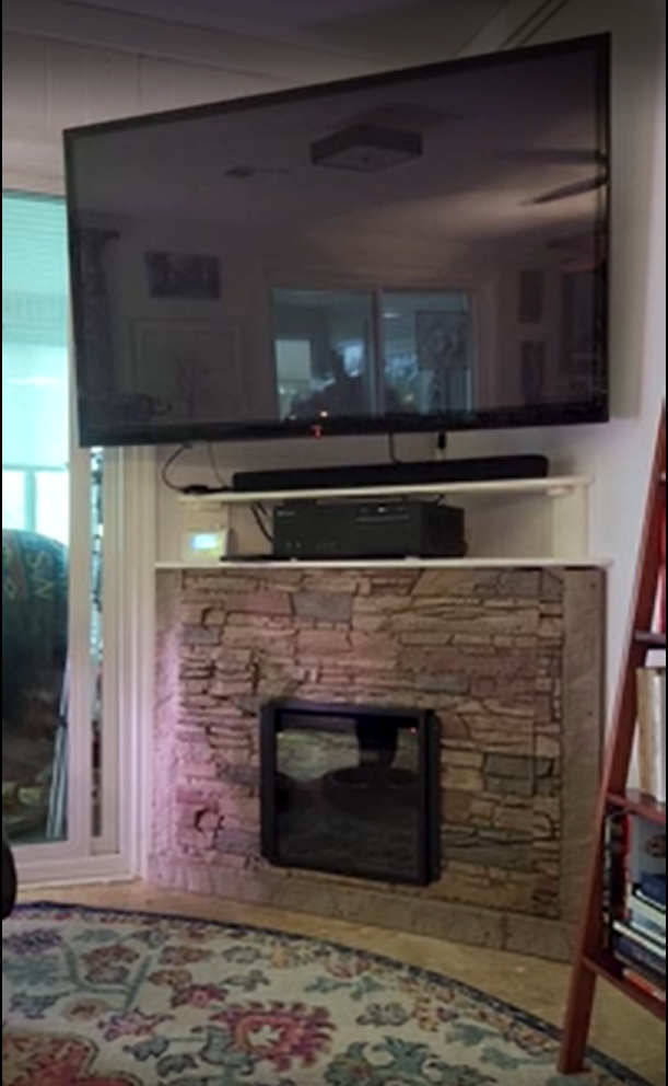 A DIY entertainment center and fireplace surround in Desert Sunrise Stacked Stone.