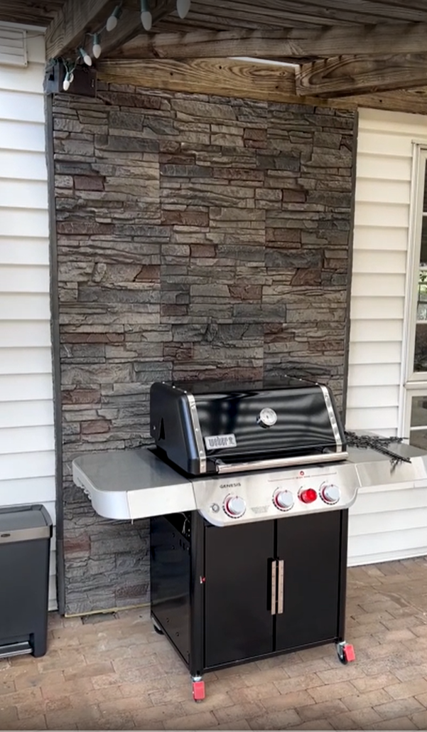 An accent wall behind a grill to protect the siding, using Kenai Stacked Stone panels.