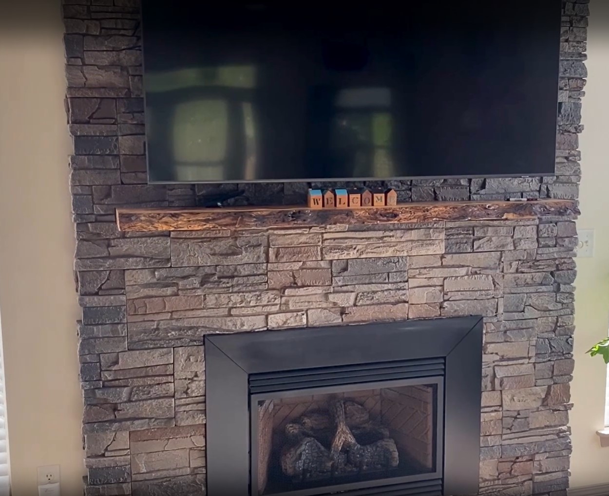 A DIY living room fireplace surround using Kenai faux stone.