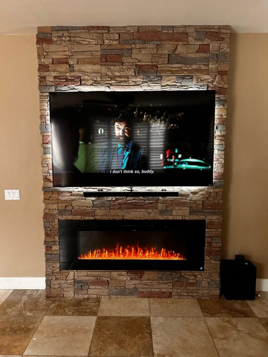 A DIY linear fireplace surround project using GenStone's Desert Sunrise faux stone panels.