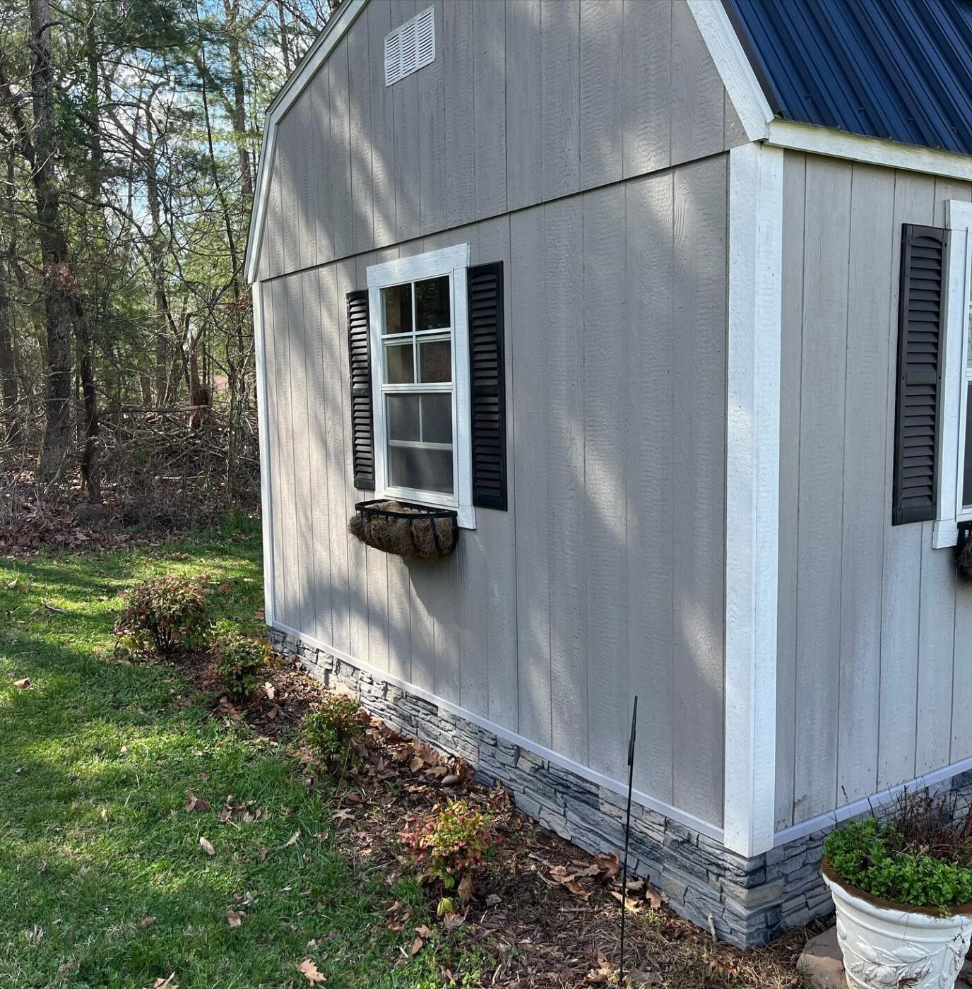 A DIY shed wainscoting project using our Northern Slate Faux Stone panels.