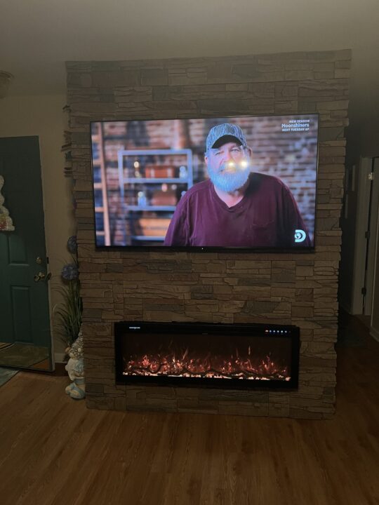 A linear fireplace surround made using GenStone's Desert Sunrise Stone Veneer.