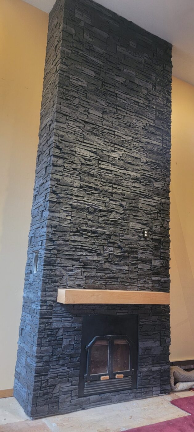 A fireplace surround design using GenStone's Iron Ore faux stone panels.