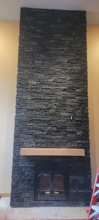 A fireplace surround design using GenStone's Iron Ore faux stone panels.