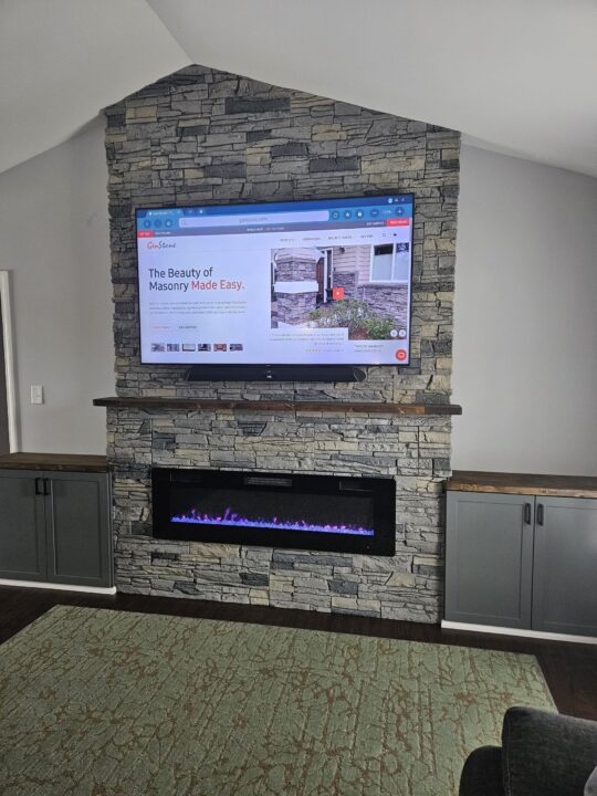 An asymmetrical fireplace surround using GenStone's Northern Slate Faux Stone panels.