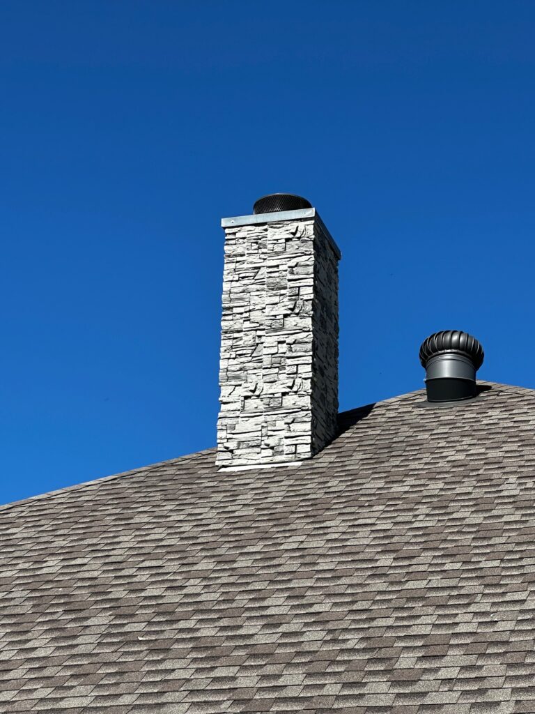 A home exterior chimney designed using GenStone's Arctic Smoke Stone Veneer.