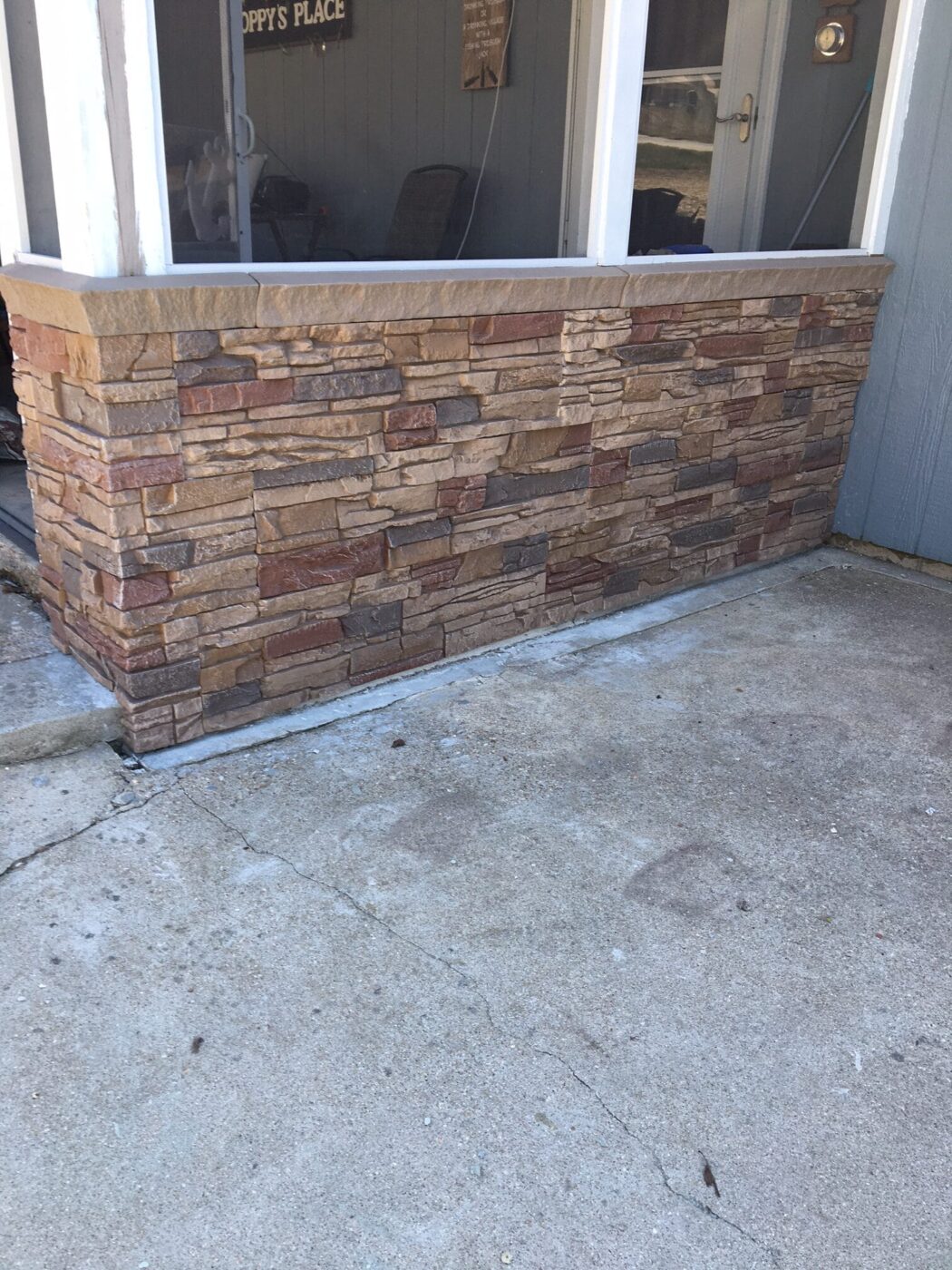 A screened-in porch skirting project made using GenStone's Desert Sunrise faux stone panels.