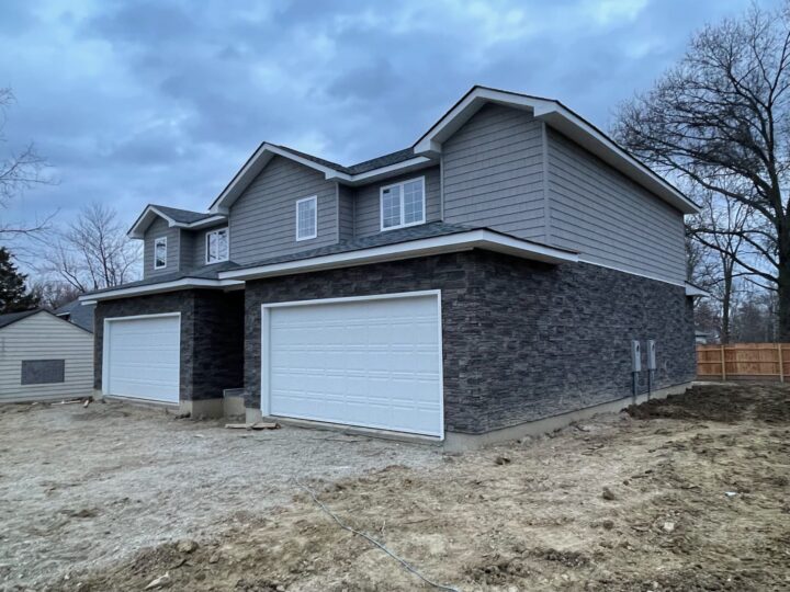 A siding project on a duplex using GenStone's Kenai faux stone panels.