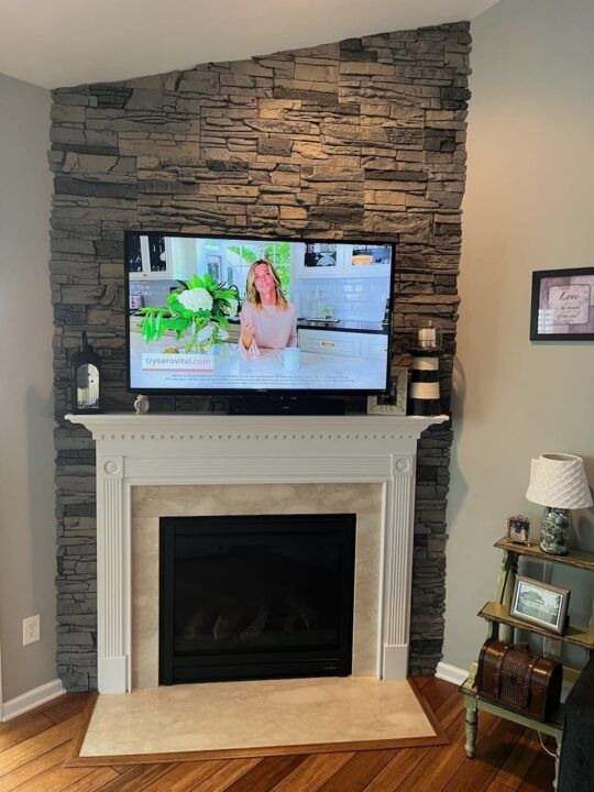 A home fireplace surround made using GenStone's Northern Slate Faux Stone.