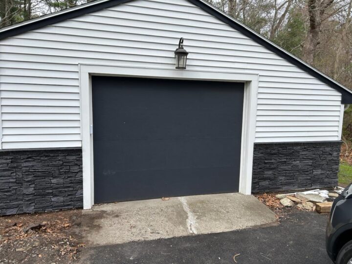 A DIY garage wainscoting idea that was completed using GenStone's Iron Ore Stacked Stone panels.