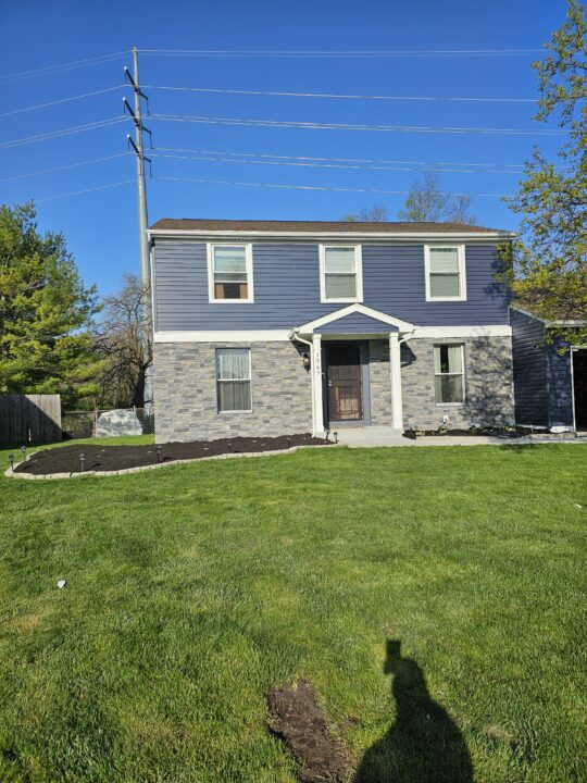 A home siding and chimney project made using GenStone's Northern Slate faux stone panels.