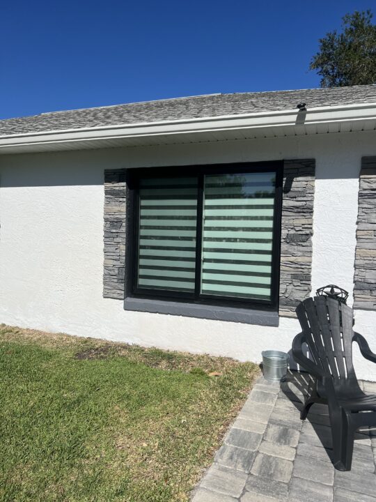 A unique exterior shutters project made with GenStone's Northern Slate faux stone panels.