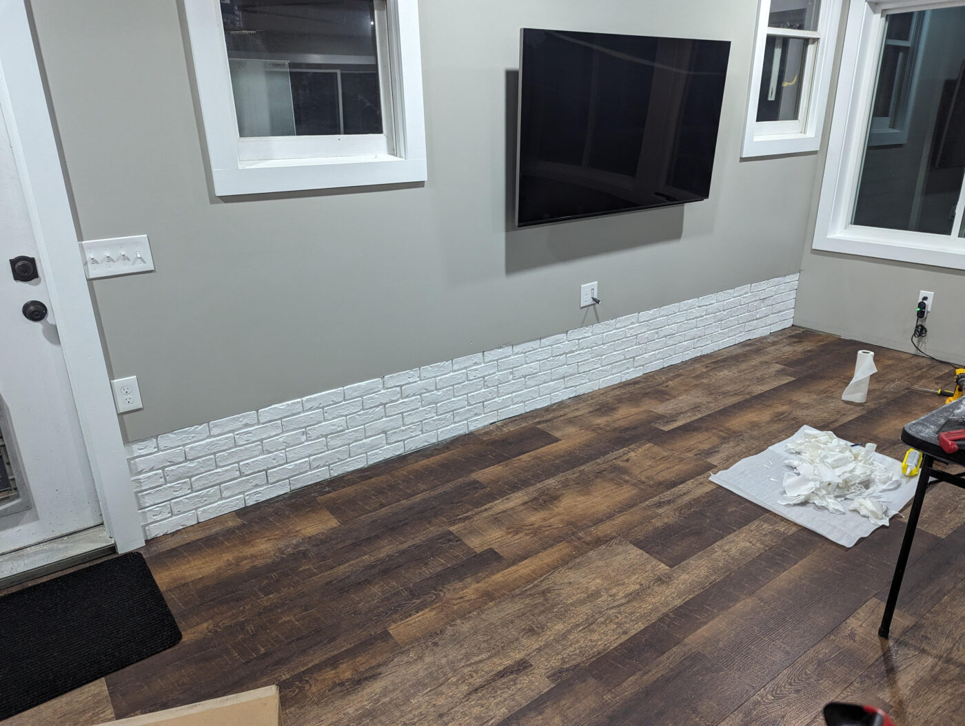 A DIY floorboard skirting project that uses GenStone's White Brick Veneer panels.