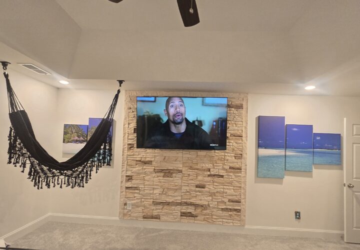 An accent wall in a basement that was made using GenStone's Vanilla Bean Stacked Stone panels.