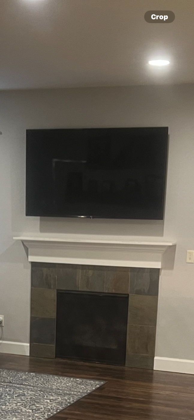 Before the completion of a DIY fireplace surround remodel idea that was brought to life using GenStone's Iron Ore Stacked Stone.