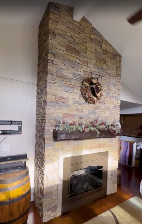 The before and after of a DIY fireplace surround made using GenStone's Desert Sunrise Stacked Stone panels.