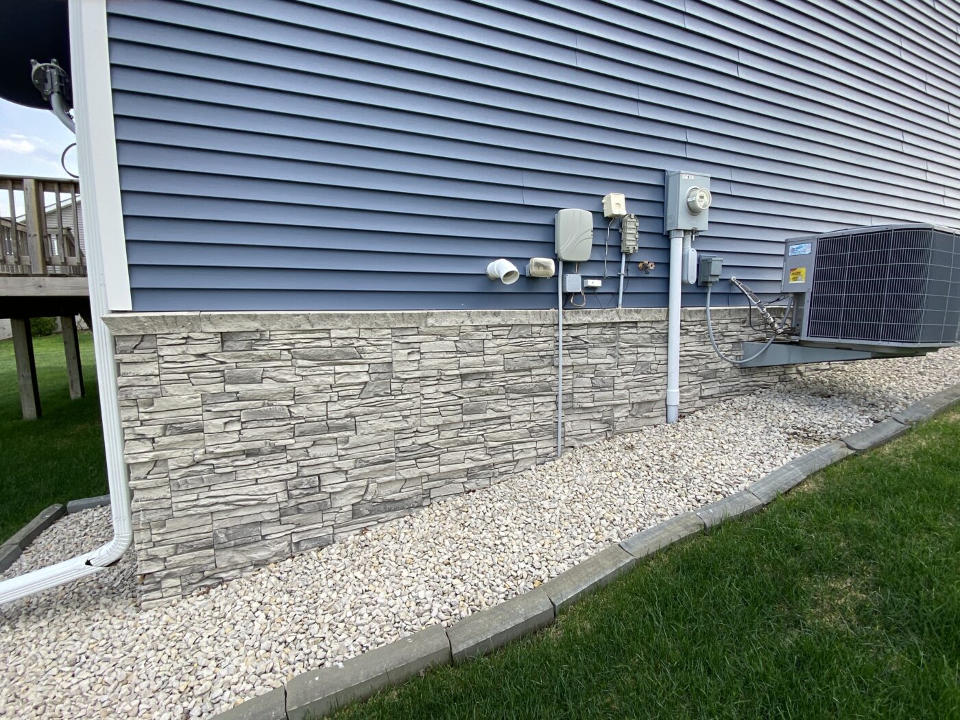 John created this light gray foundation cover using GenStone's Arctic Smoke Stacked Stone panels.