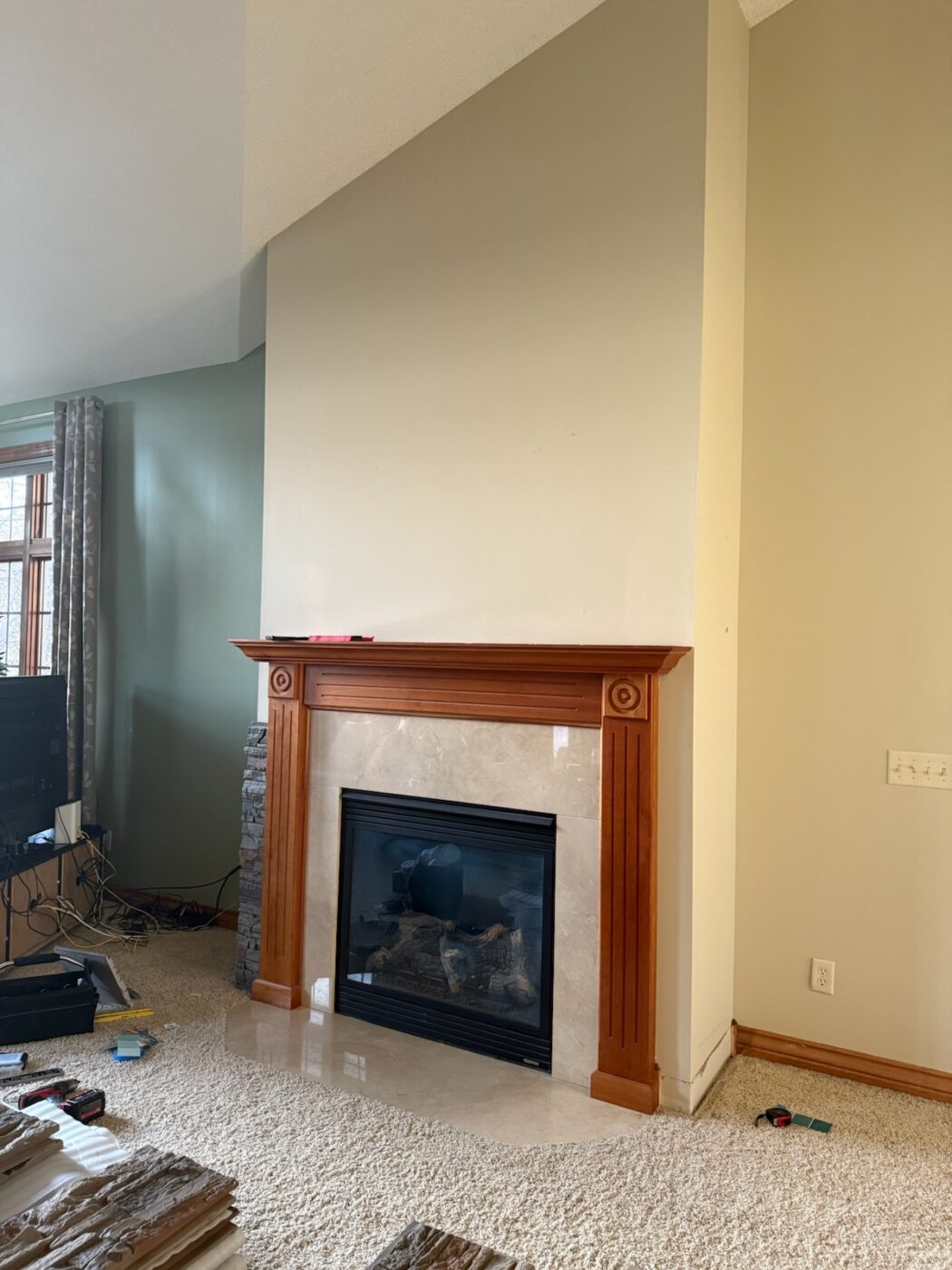 This is how Stacy's fireplace looked before Stacy utilized GenStone's Kenai Stacked Stone panels to create a beautiful brown slate fireplace​.