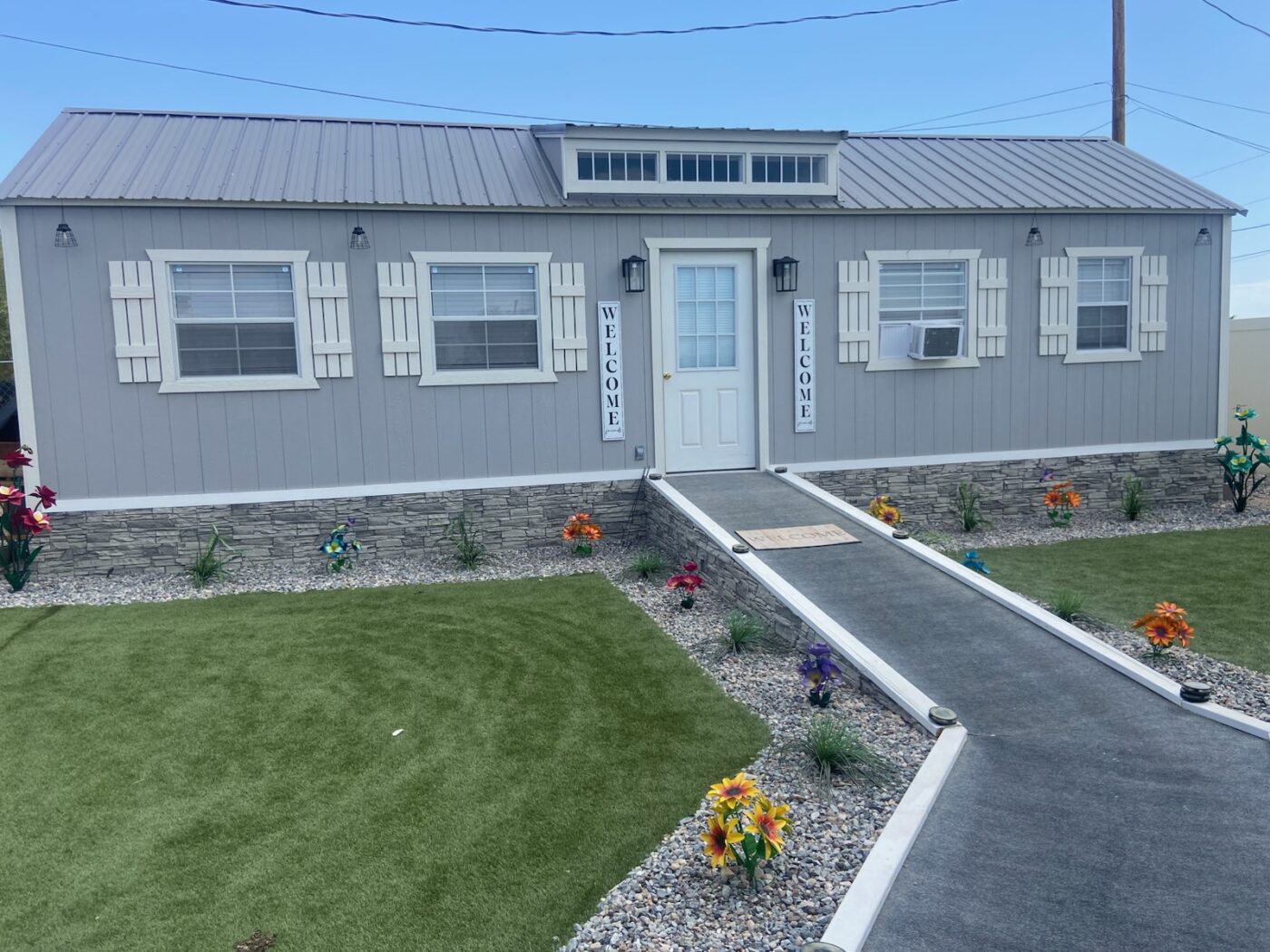 This home has a light stone foundation cover up that was created using GenStone's Arctic Smoke Stacked Stone panels.