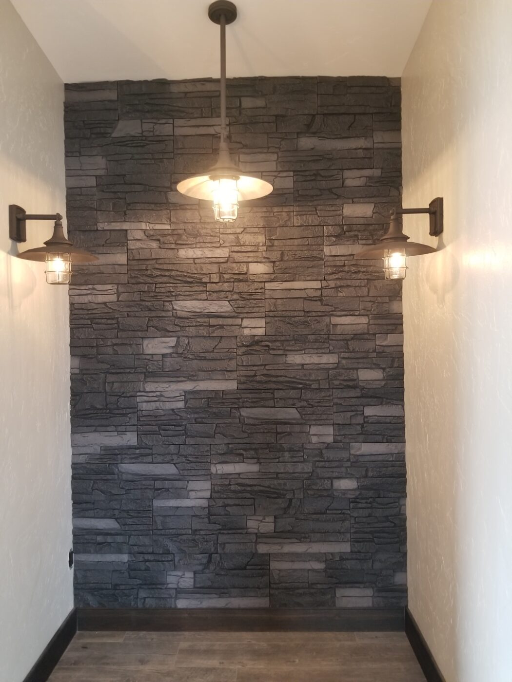 This charcoal accent wall was created using GenStone's Iron Ore Stacked Stone panels.
