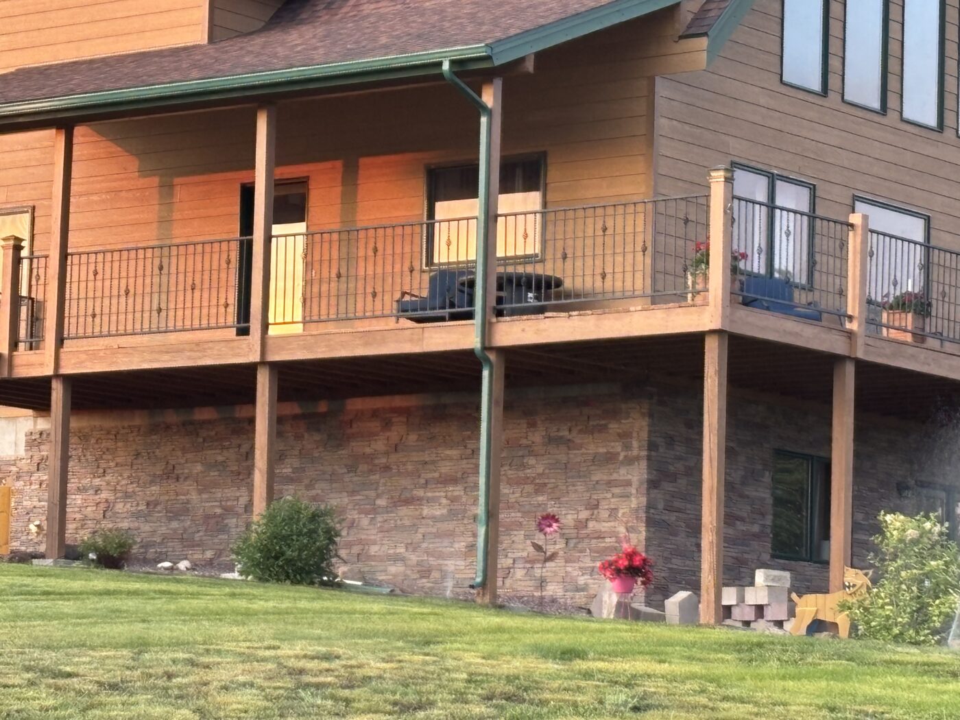 This is a home exterior that has been upgraded with a DIY slate foundation cover up with GenStone's Desert Sunrise Stacked Stone panels.