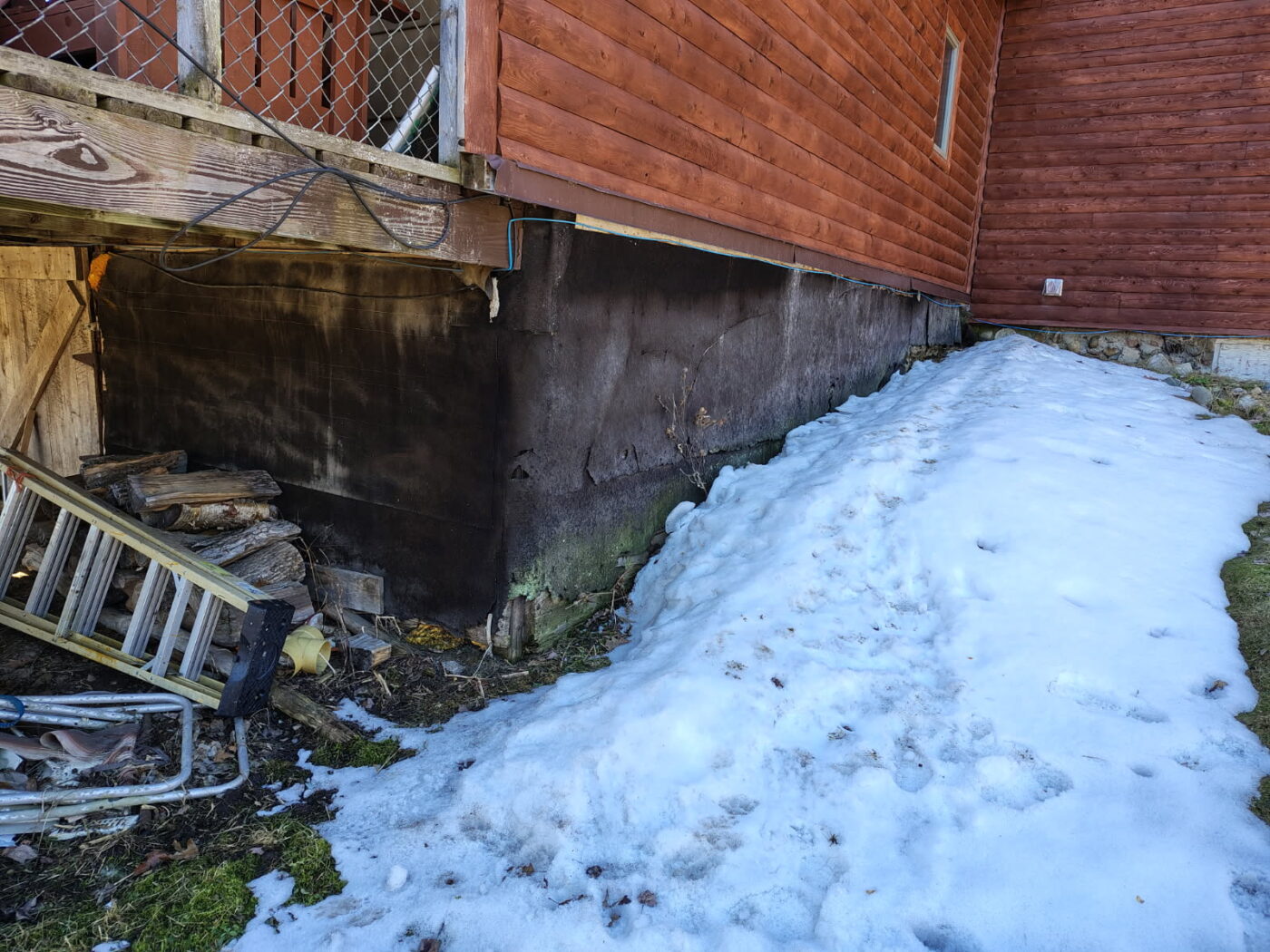 This cabin's foundation before the owner completed a cabin foundation cover up project using GenStone's Desert Sunrise Stacked Stone panels.