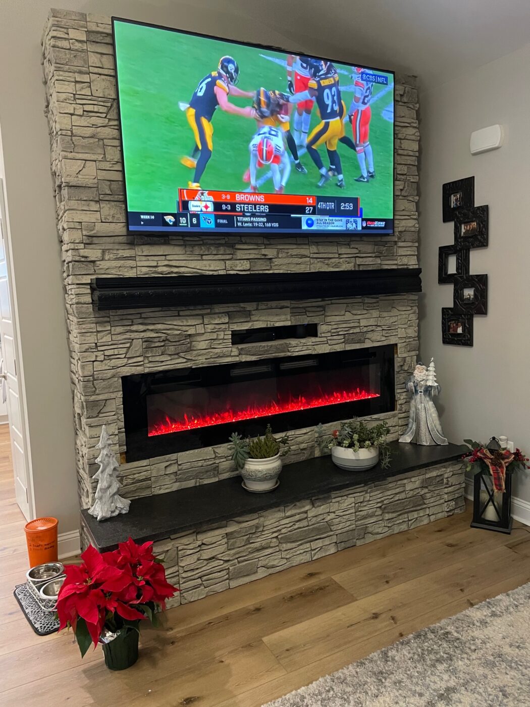 This light gray stone fireplace​ was crafted using Arctic Smoke Stacked Stone panels from GenStone.