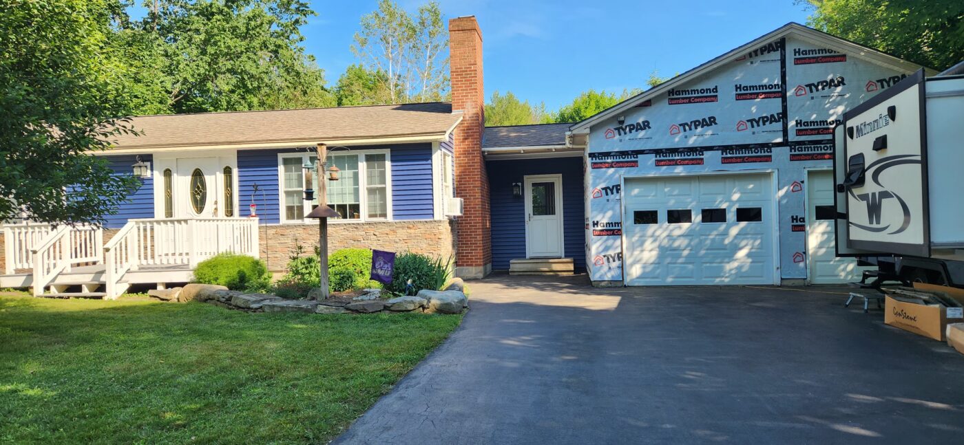 A kenai faux stone wainscoting project on a home exterior that was created using GenStone's Stacked Stone panels.