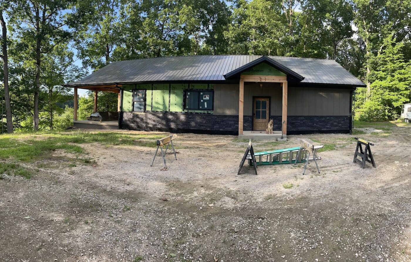 An iron ore stone wainscoting project on a home exterior that was created using GenStone's Stacked Stone panels.