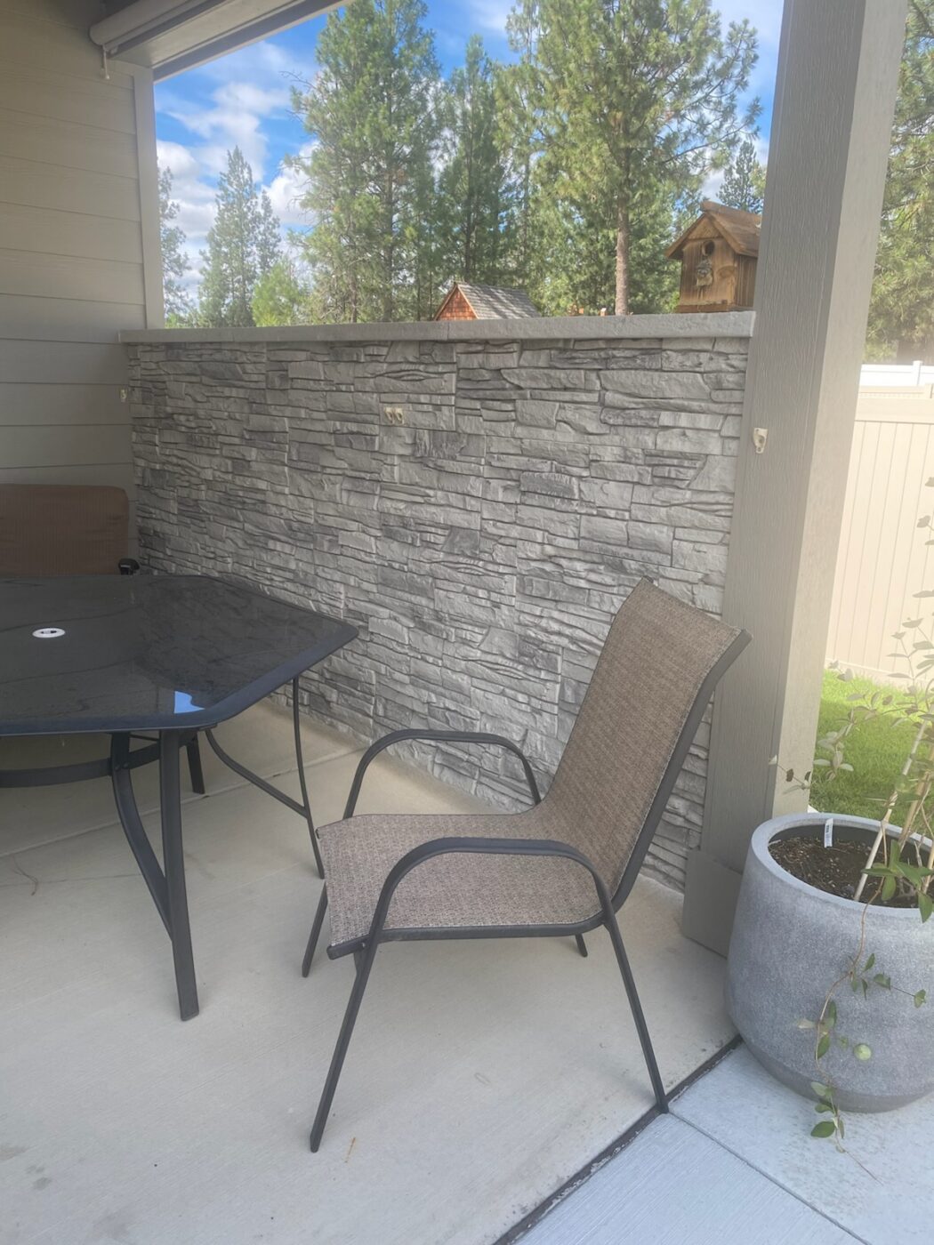 An arctic smoke stone accent wall project on a home's patio that was created using GenStone's Stacked Stone panels.