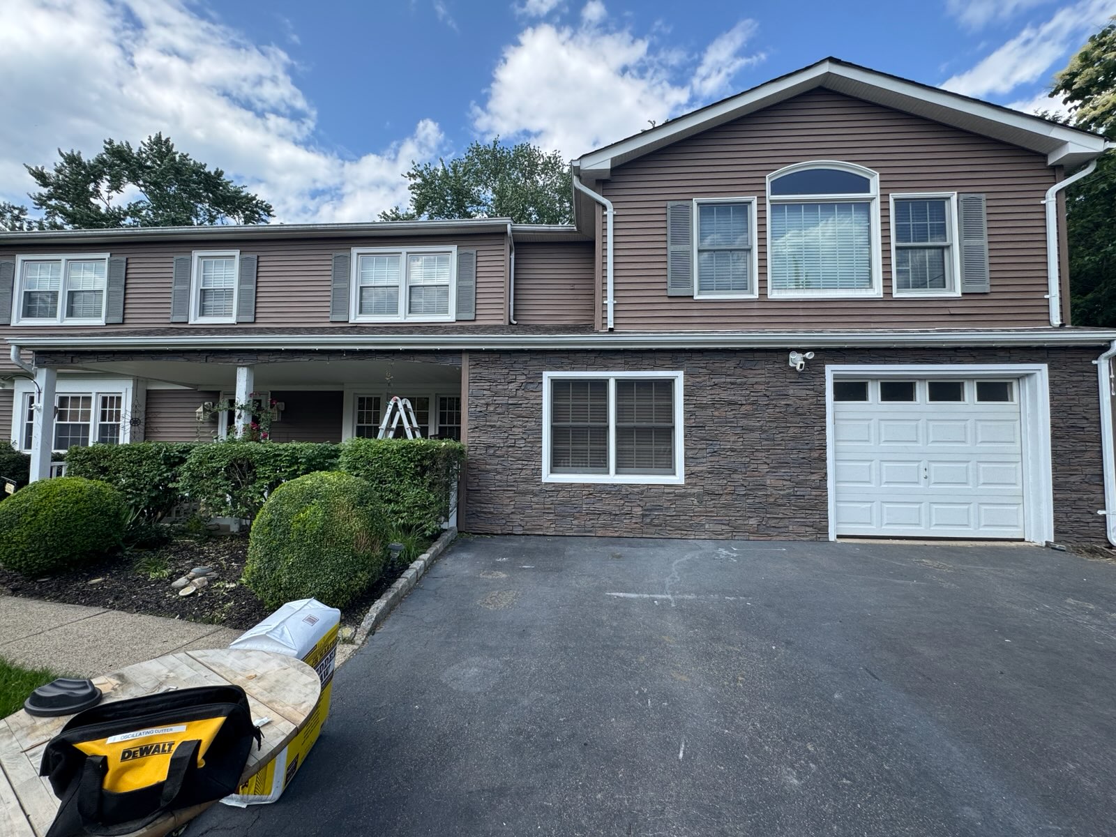 A coffee stone garage exterior project that was created using GenStone's Stacked Stone panels.